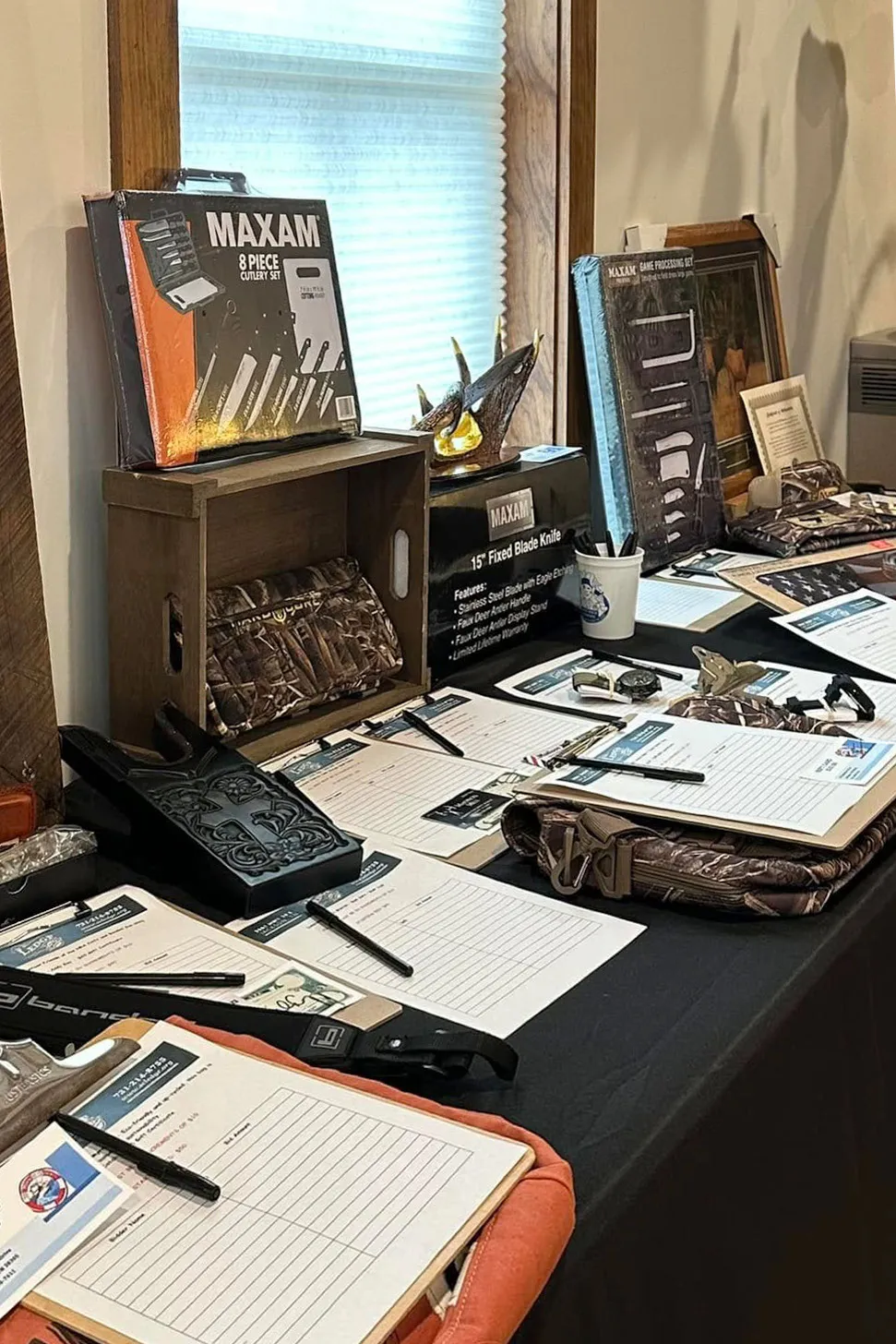 The silent auction table with bid sheets