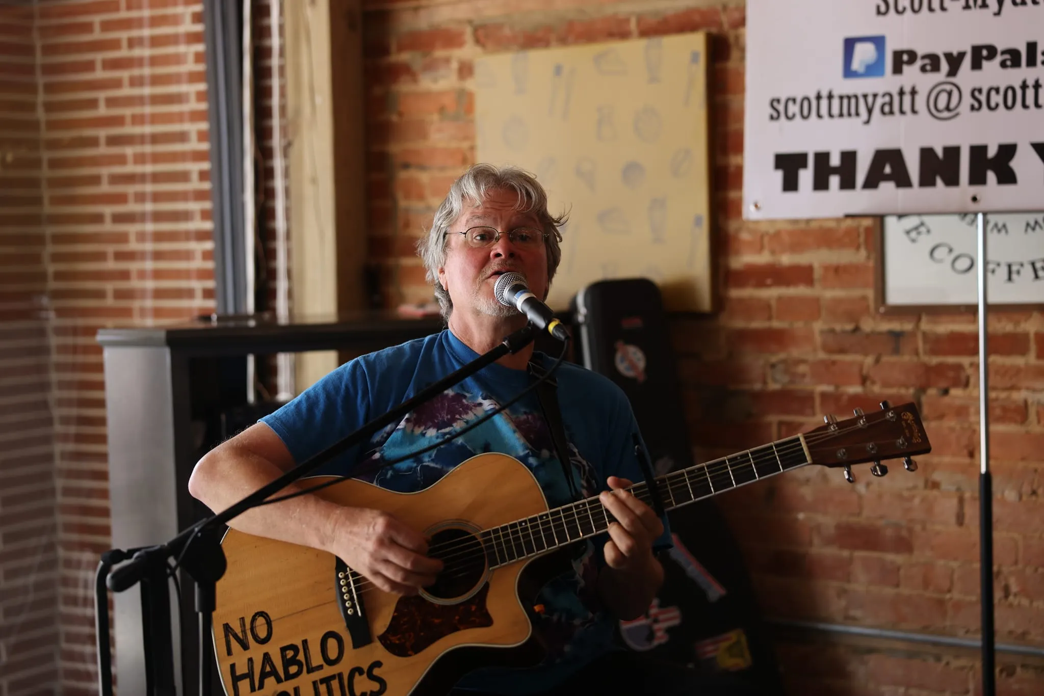 Scott Myatt playing guitar and singing