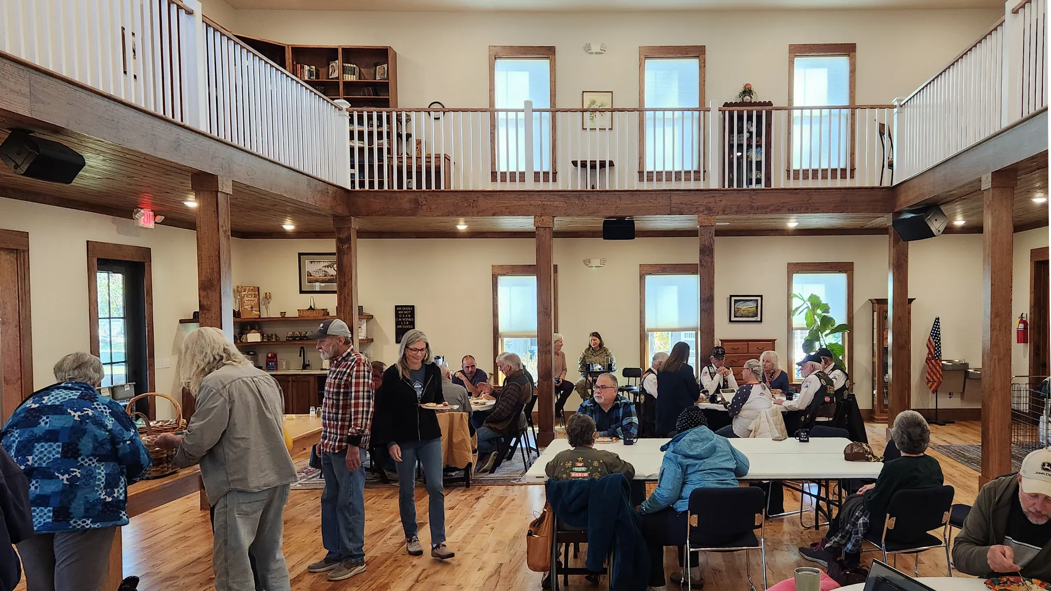 Neighbors gather at tables in the main hall of The Ledge after the ceremony.