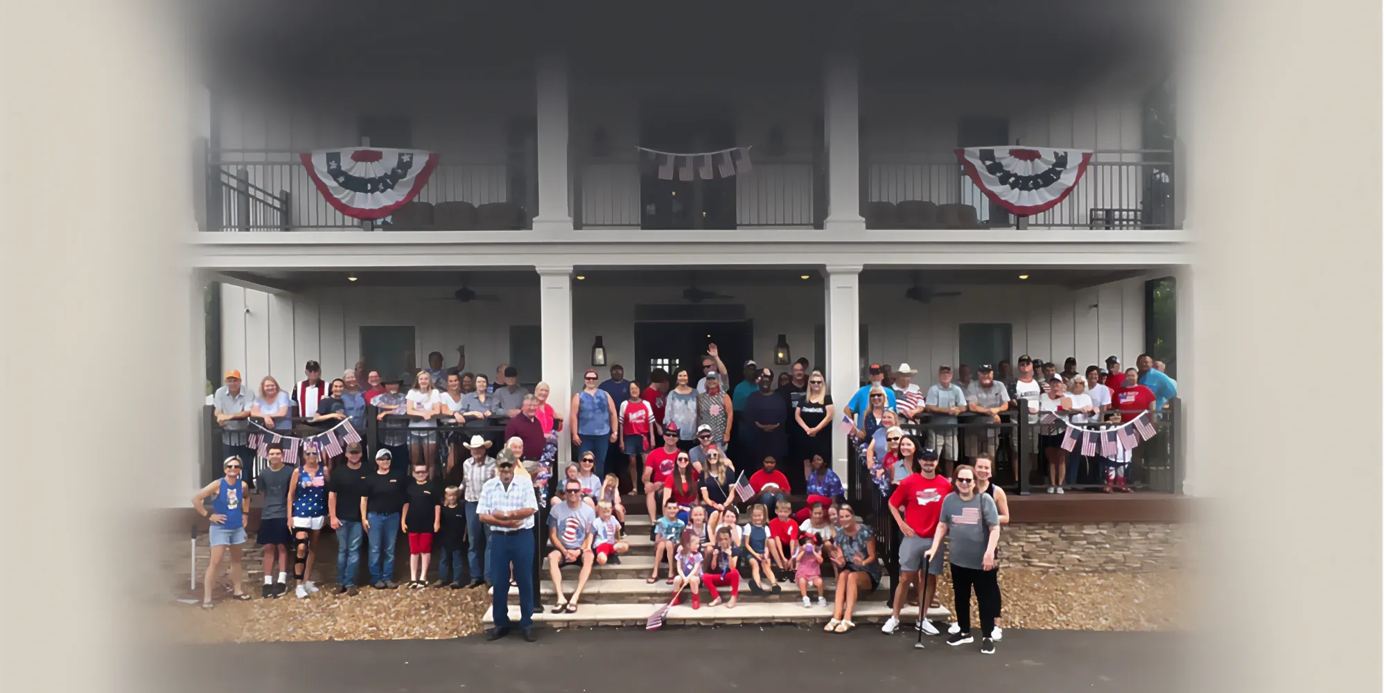 Neighbors gathered on the porch and steps of The Ledge for the Fourth of July celebration