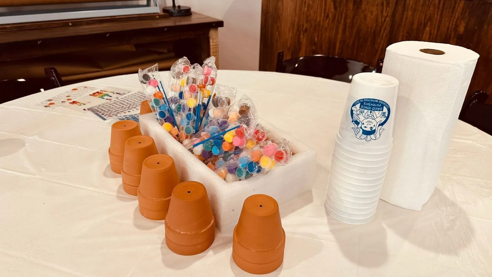 Children's clay pots and paints ready to decorate